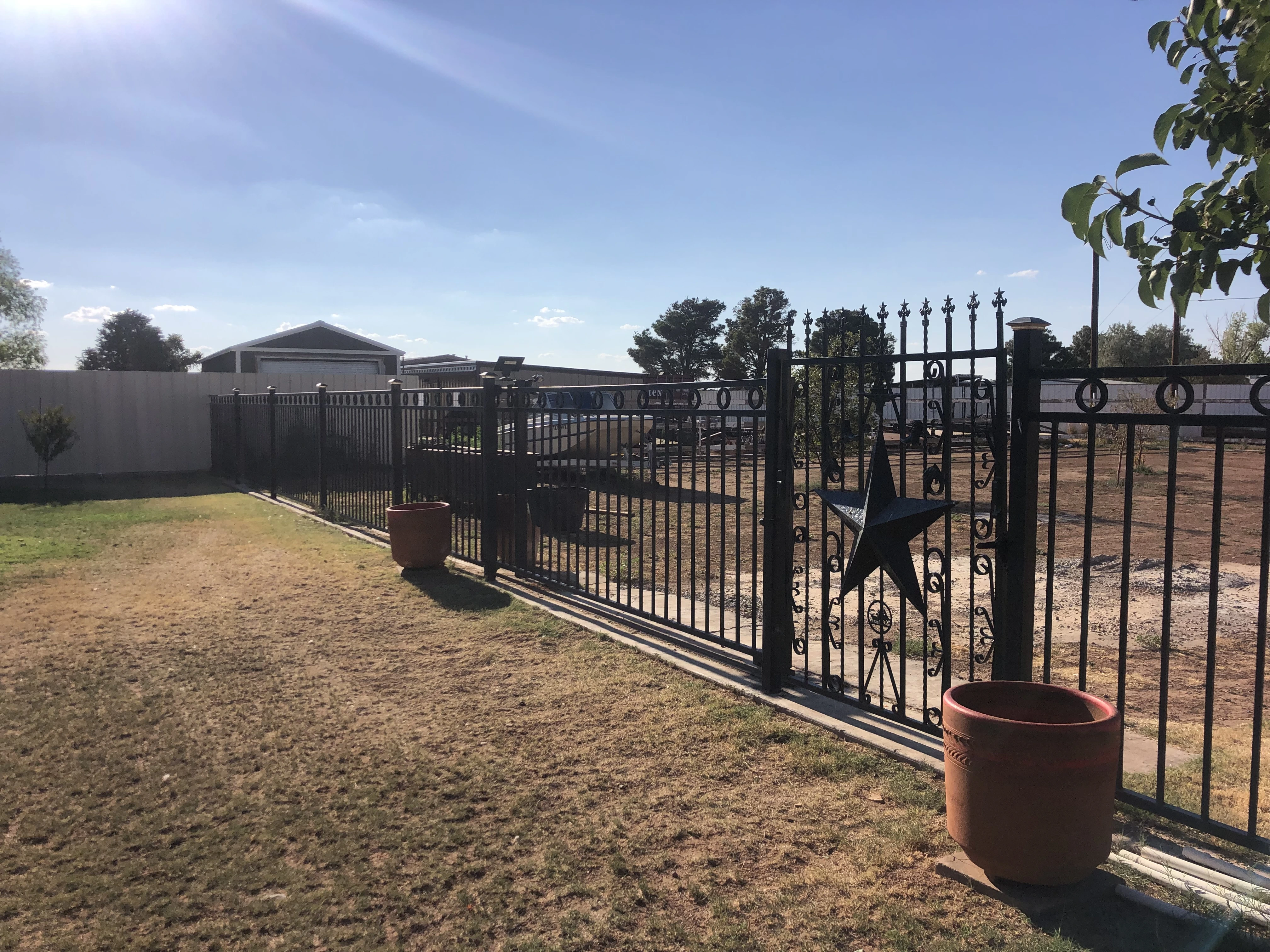 Decorative welded metal fence with matching gate installed in Lubbock Texas