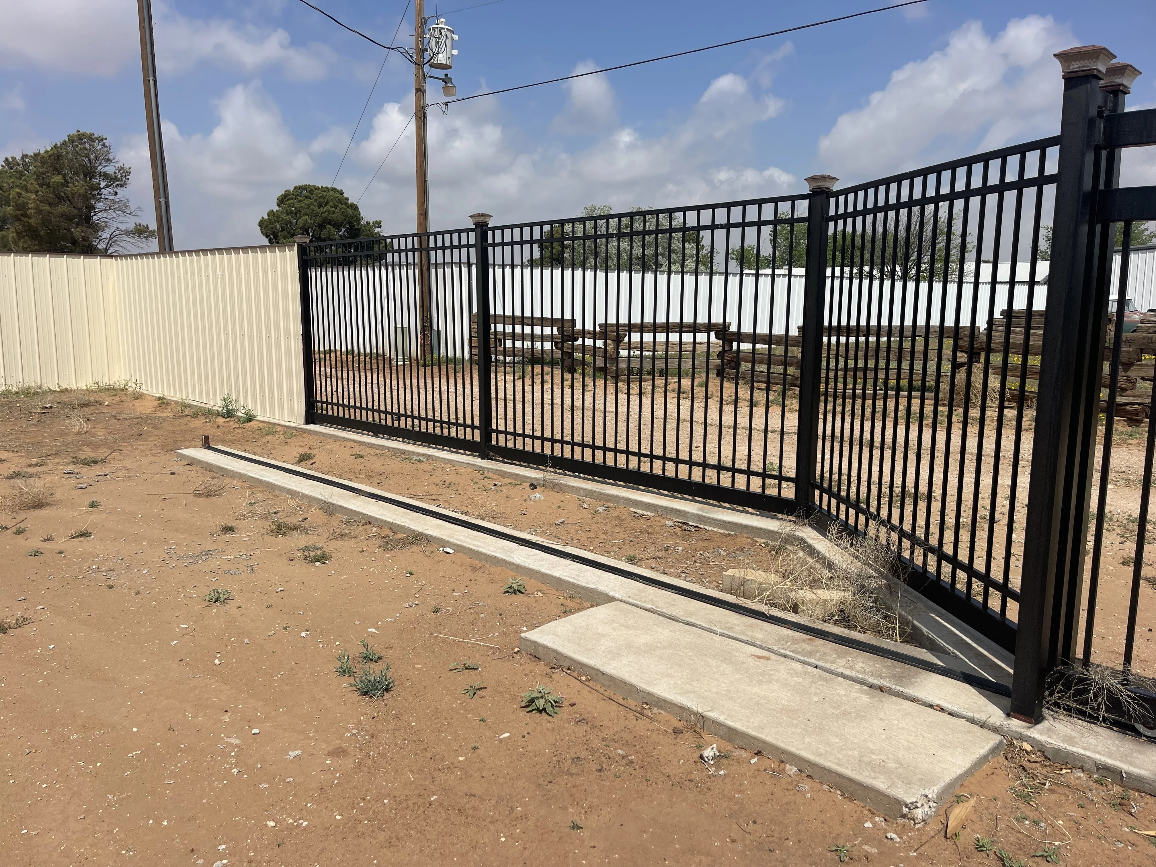 Hybrid cedar and steel privacy fence with decorative top section