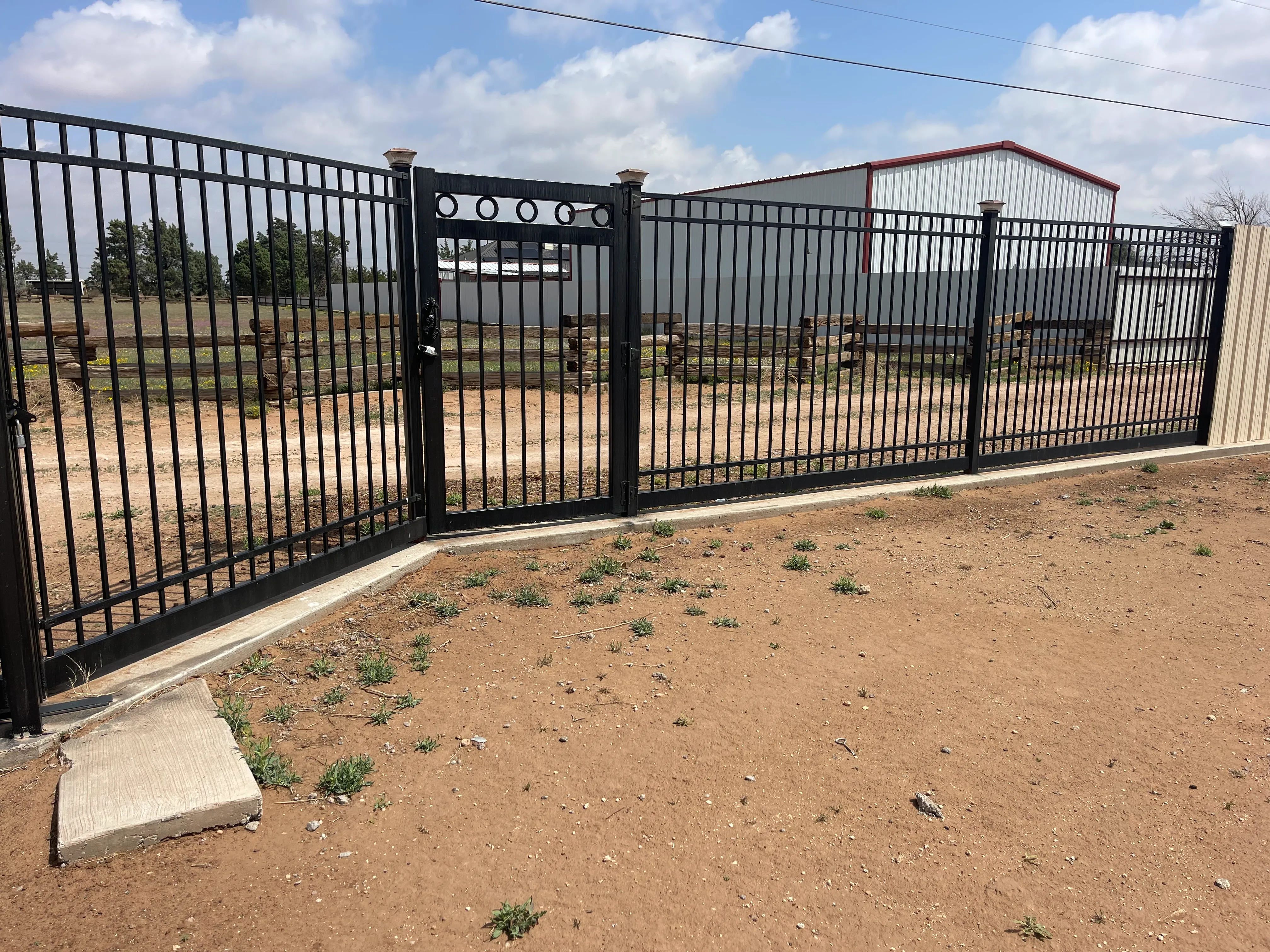 Rear view of welded steel gate framed with cedar pickets for privacy