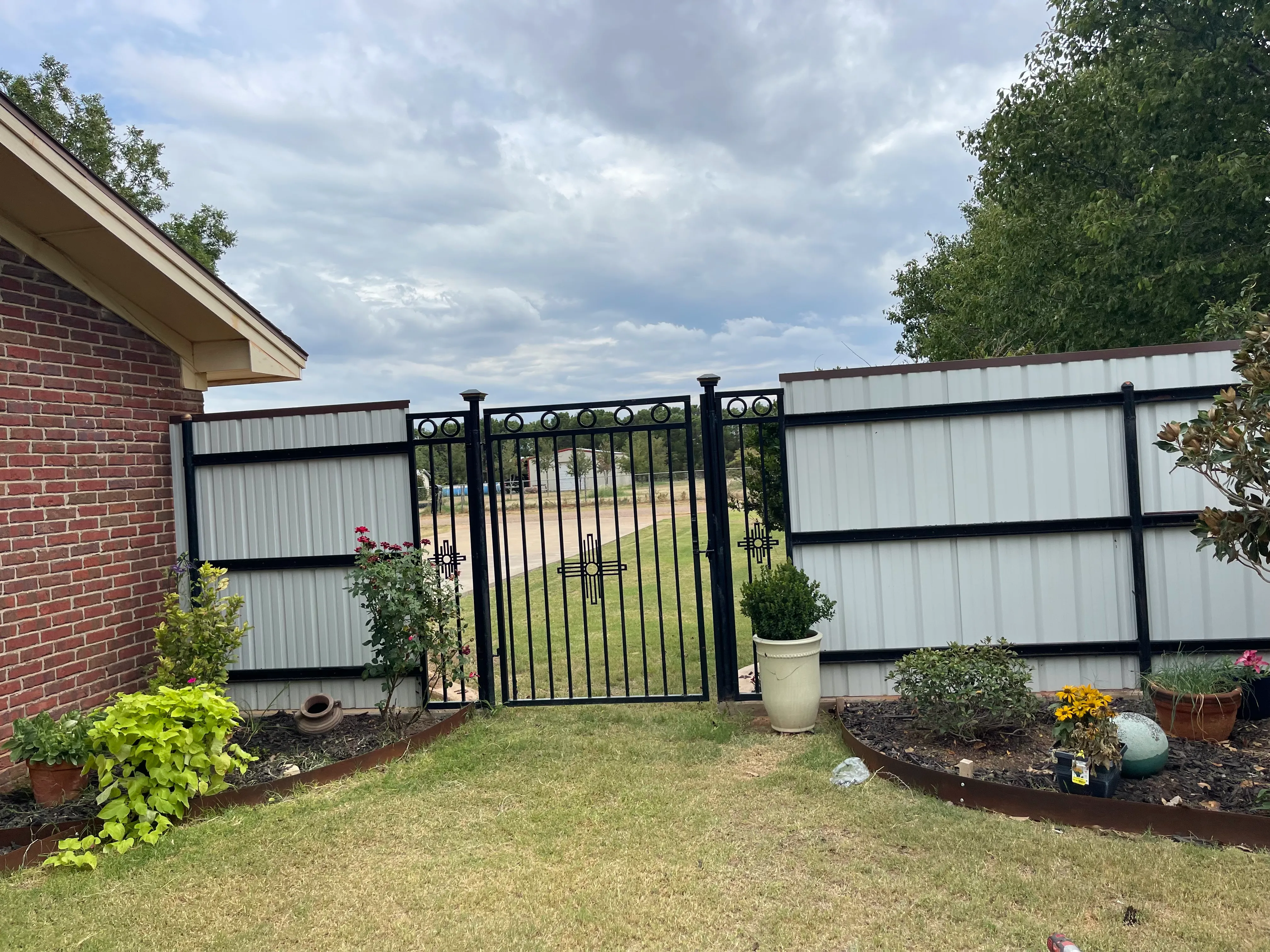 Front entry decorative iron gate with custom scrollwork and powder-coat finish