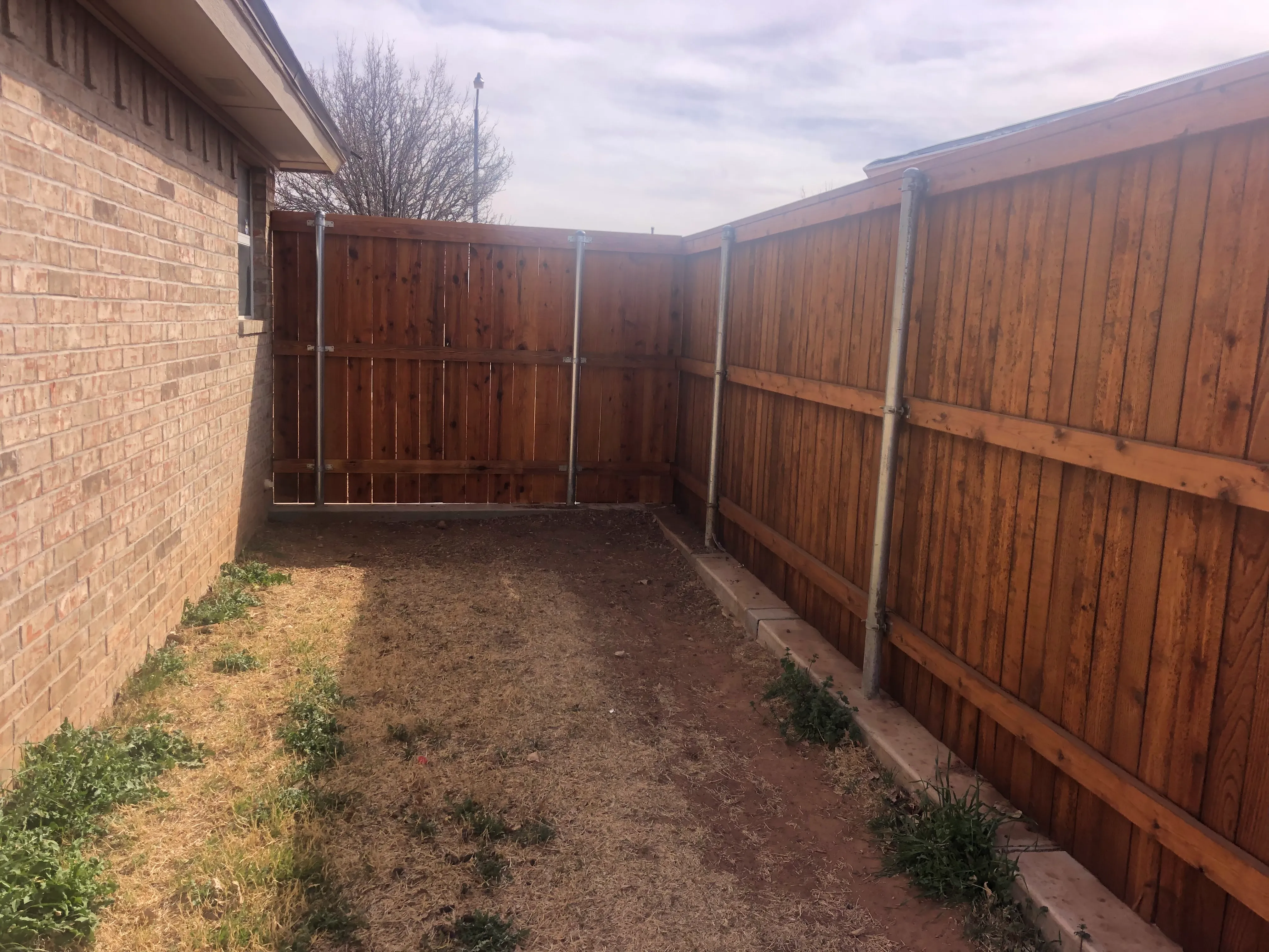 7-foot cedar privacy fence with concrete footing and straight runs