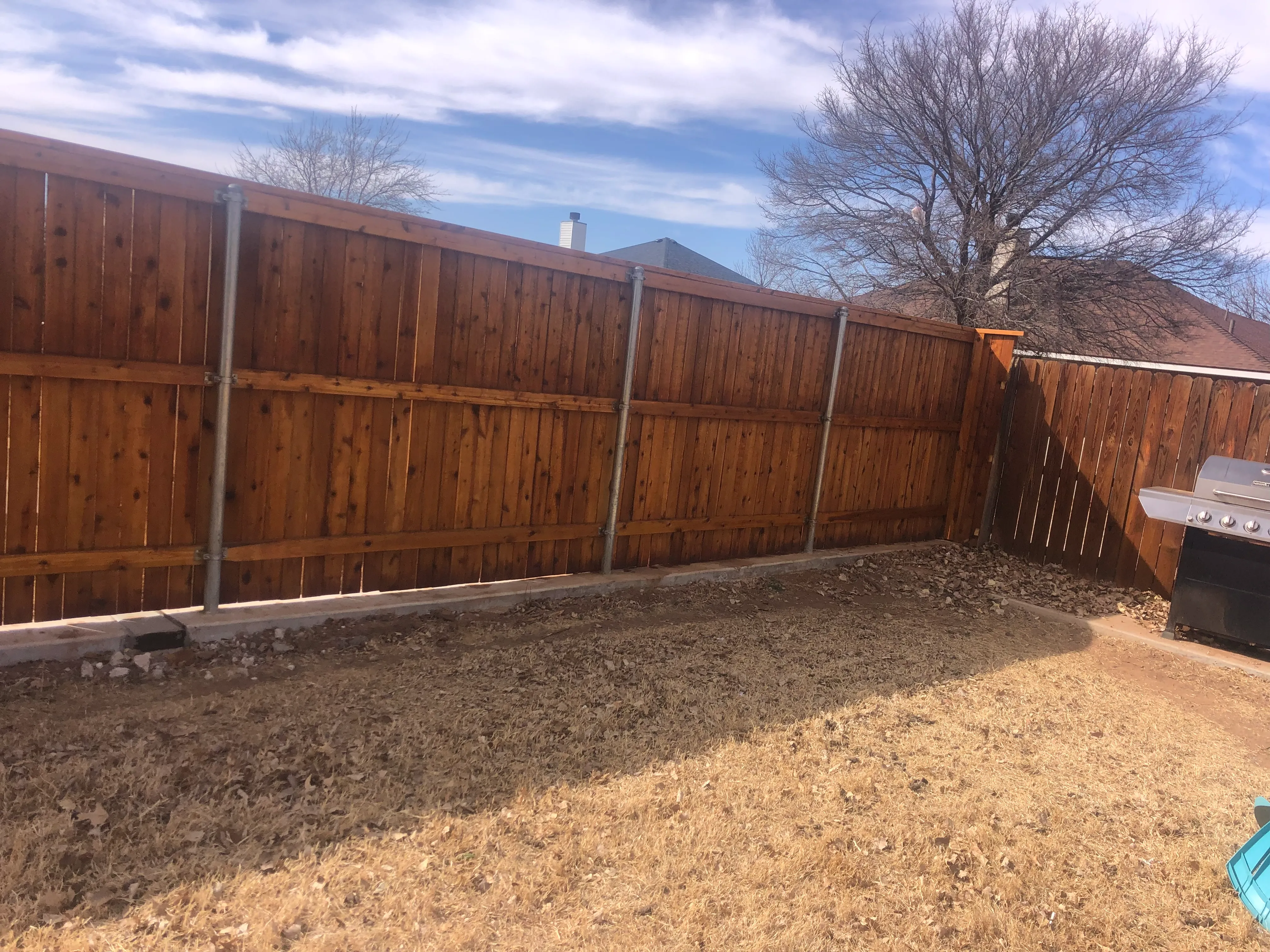 7-foot cedar privacy fence with crown cap and clean top line in West Texas