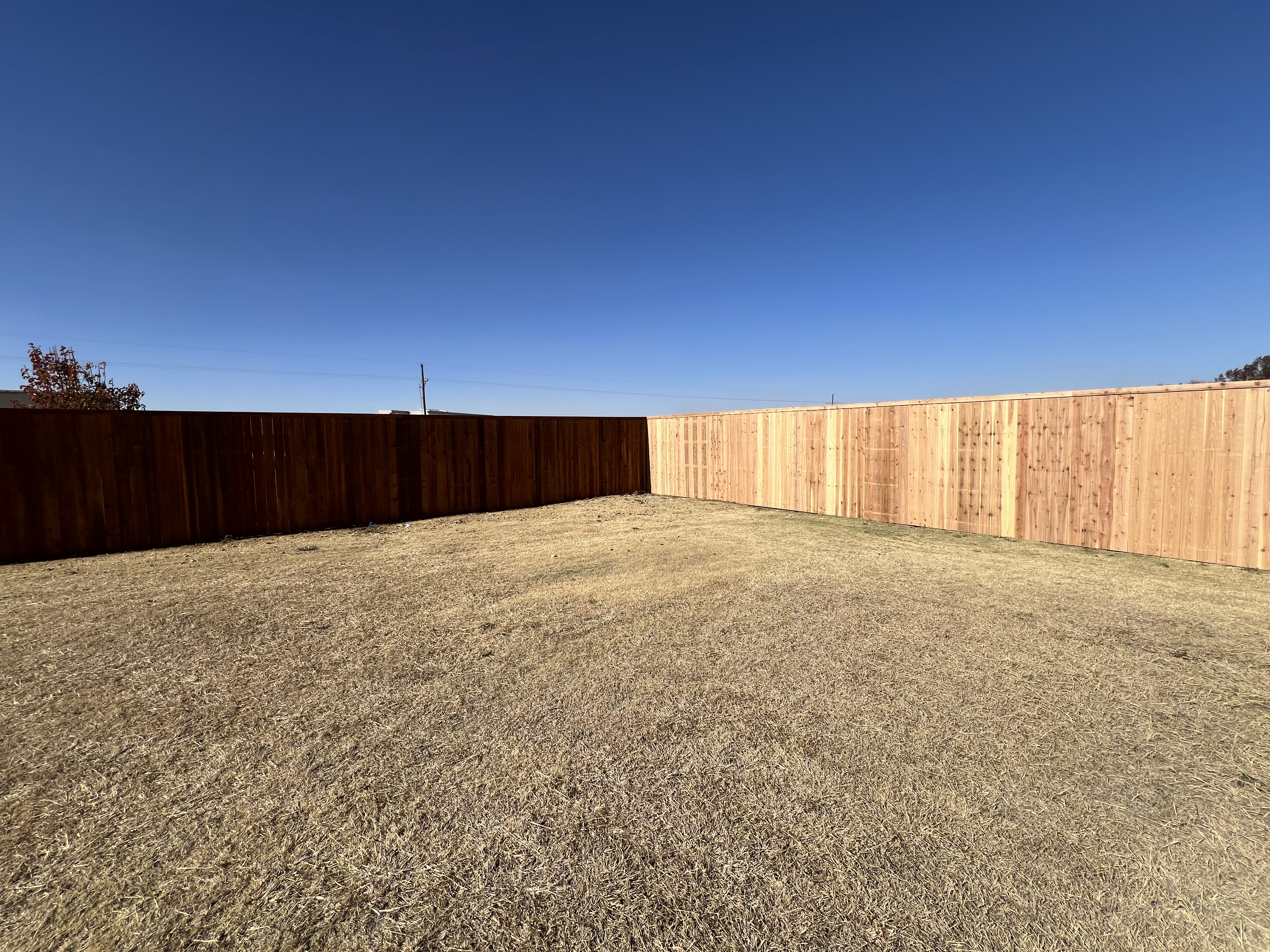 7-ft cedar fence covering 1 acre lot