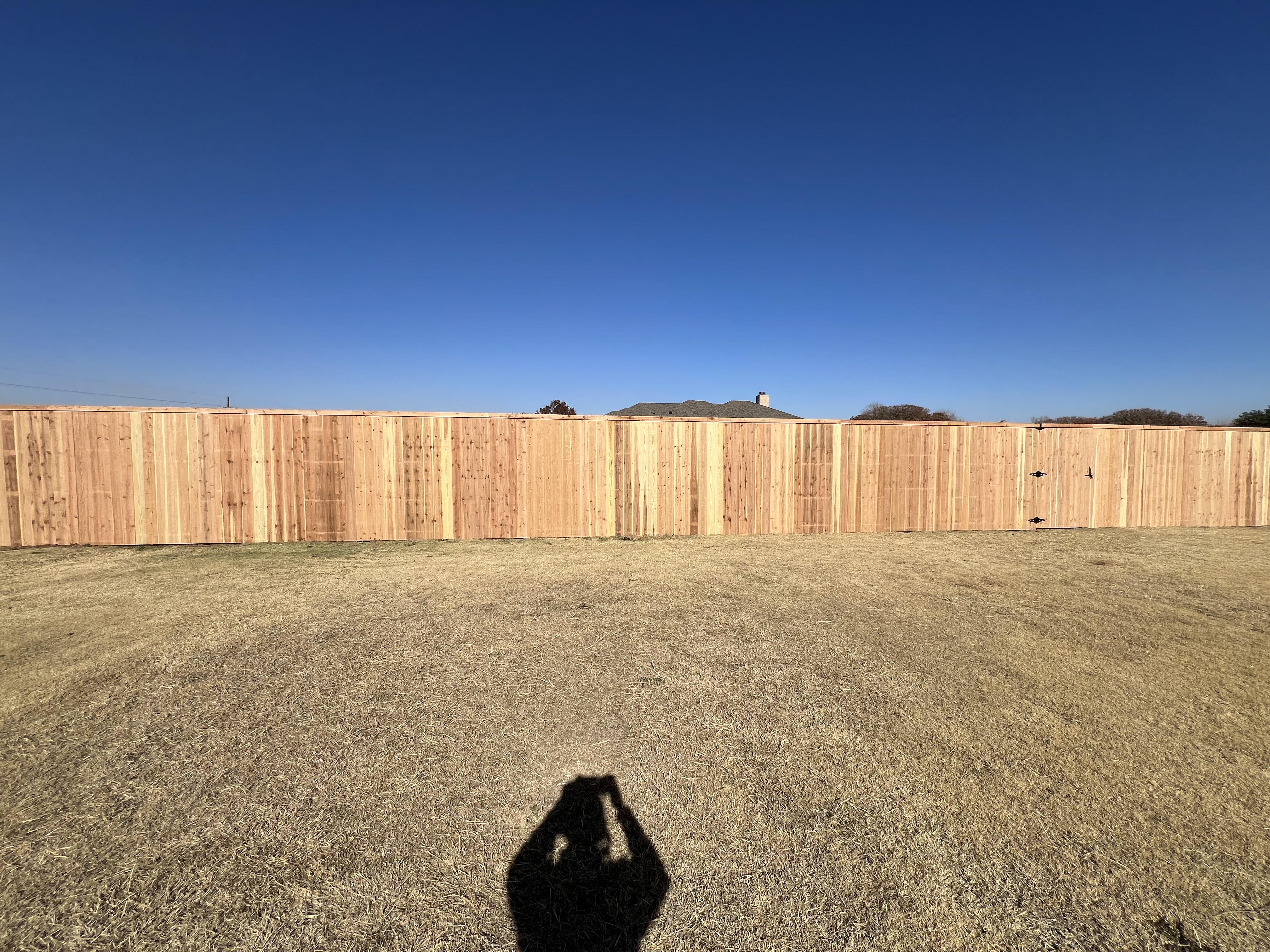7-ft cedar fence covering 1 acre lot