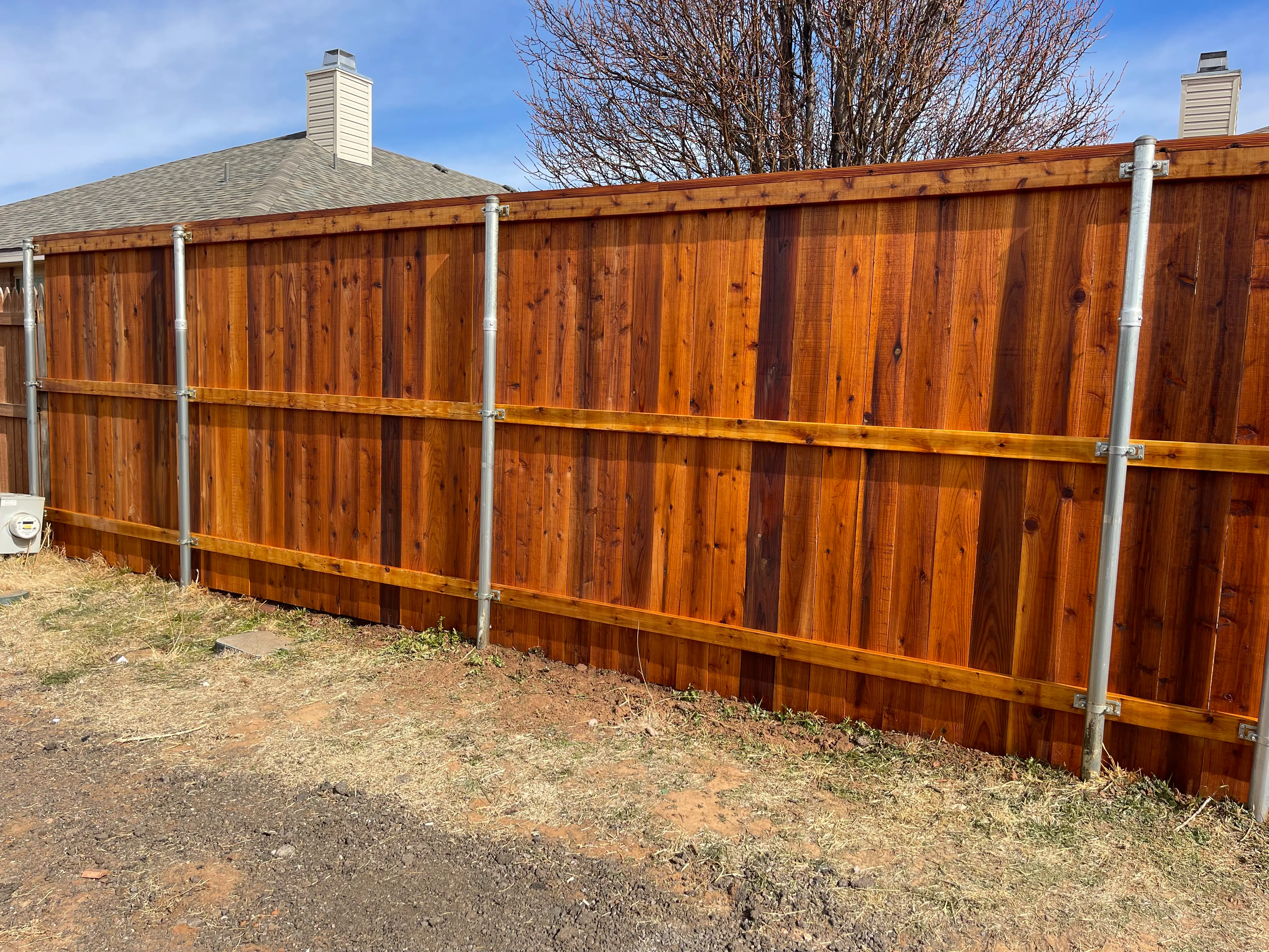 Cedar privacy fence treated with protective stain finish for longevity