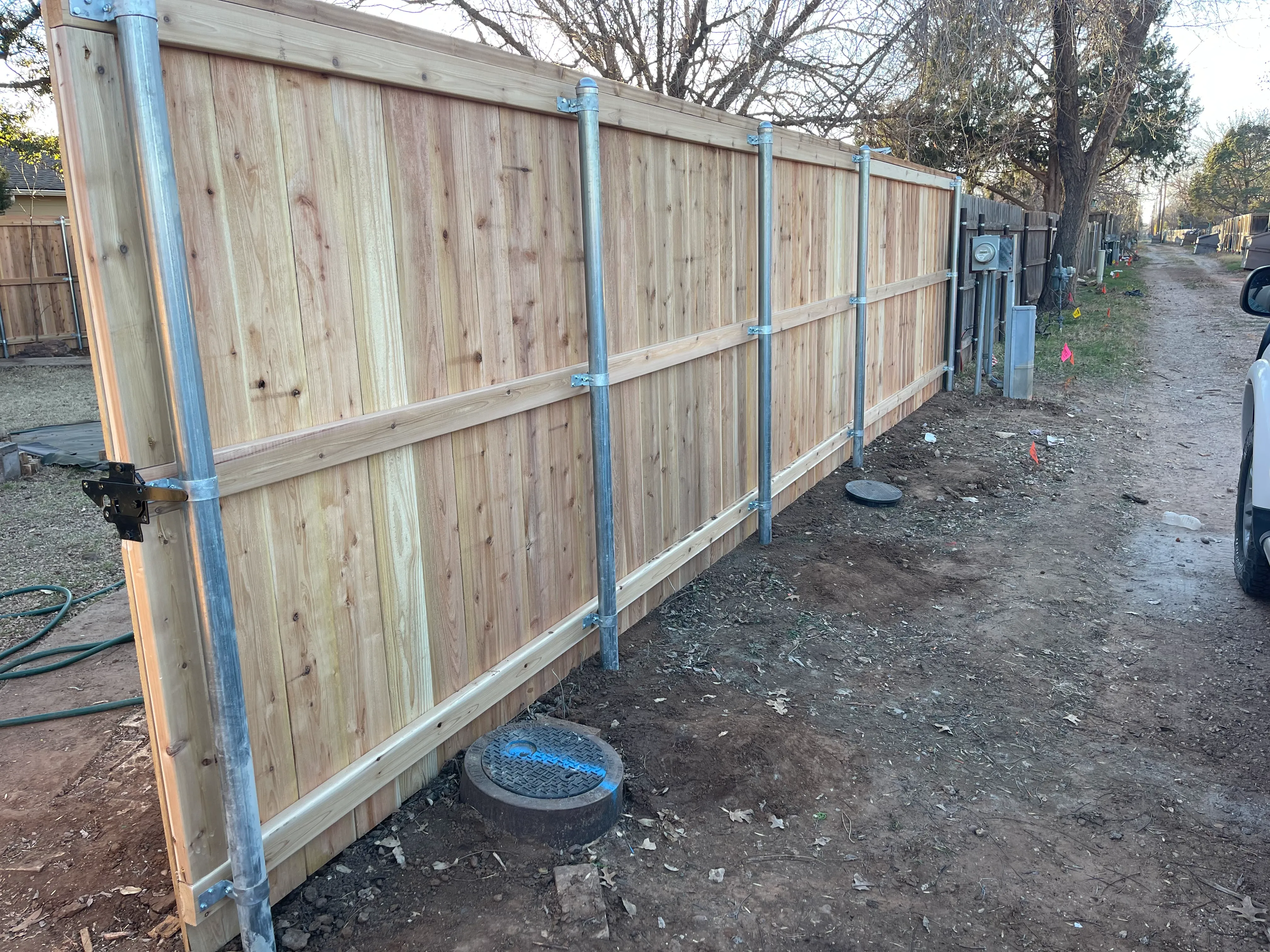 Rear property line cedar fencing build with straight alignment