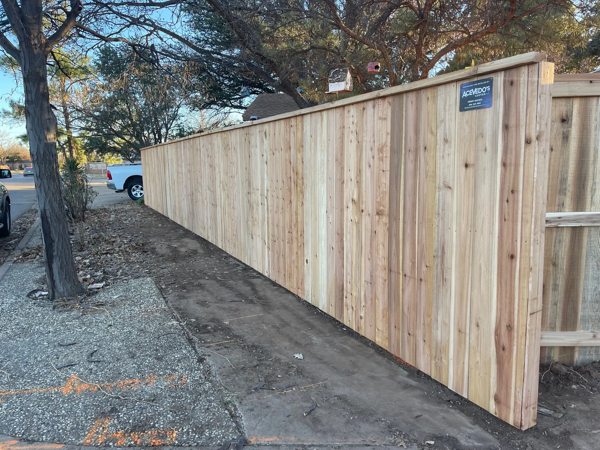 Finished cedar perimeter fence enclosing residential yard