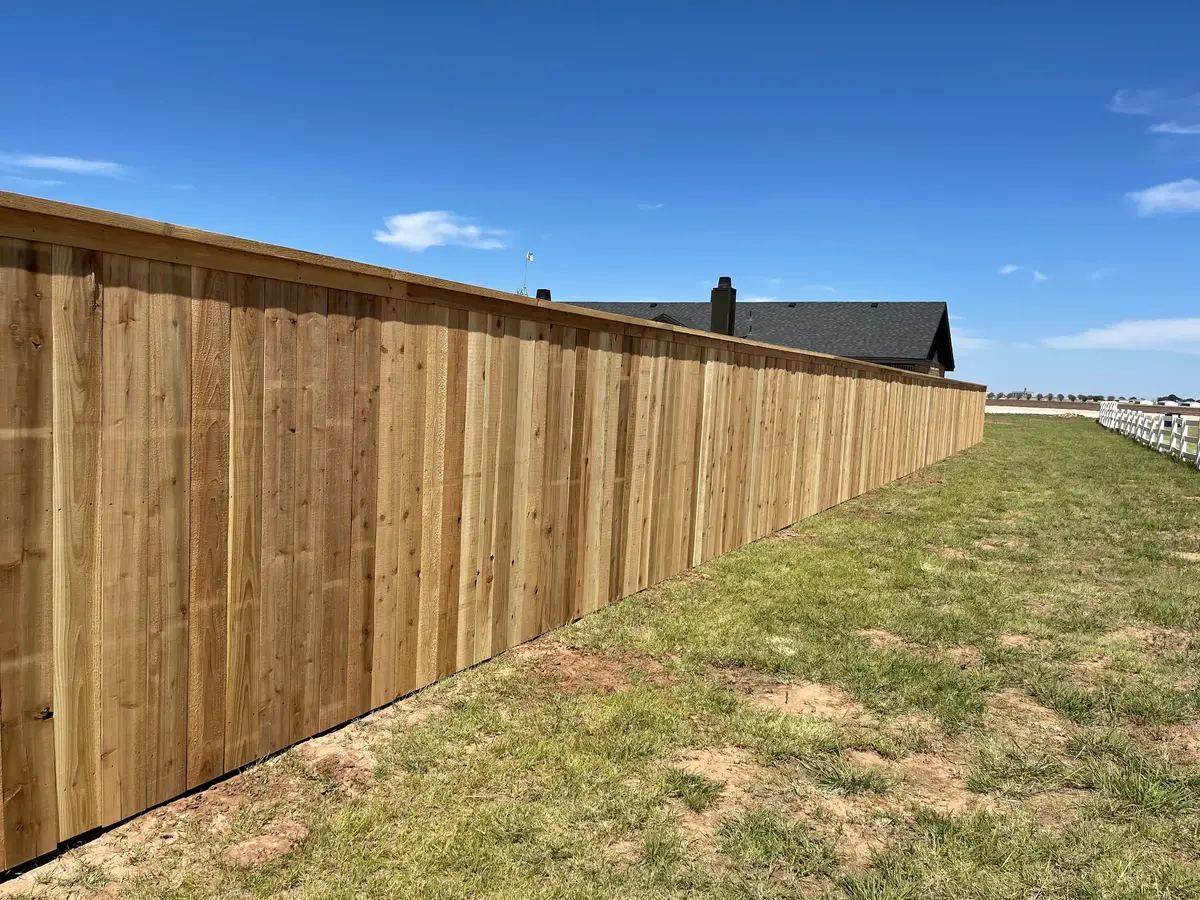 Custom 7-foot cedar fence with cap and trim built around a 1-acre home in Lubbock Texas