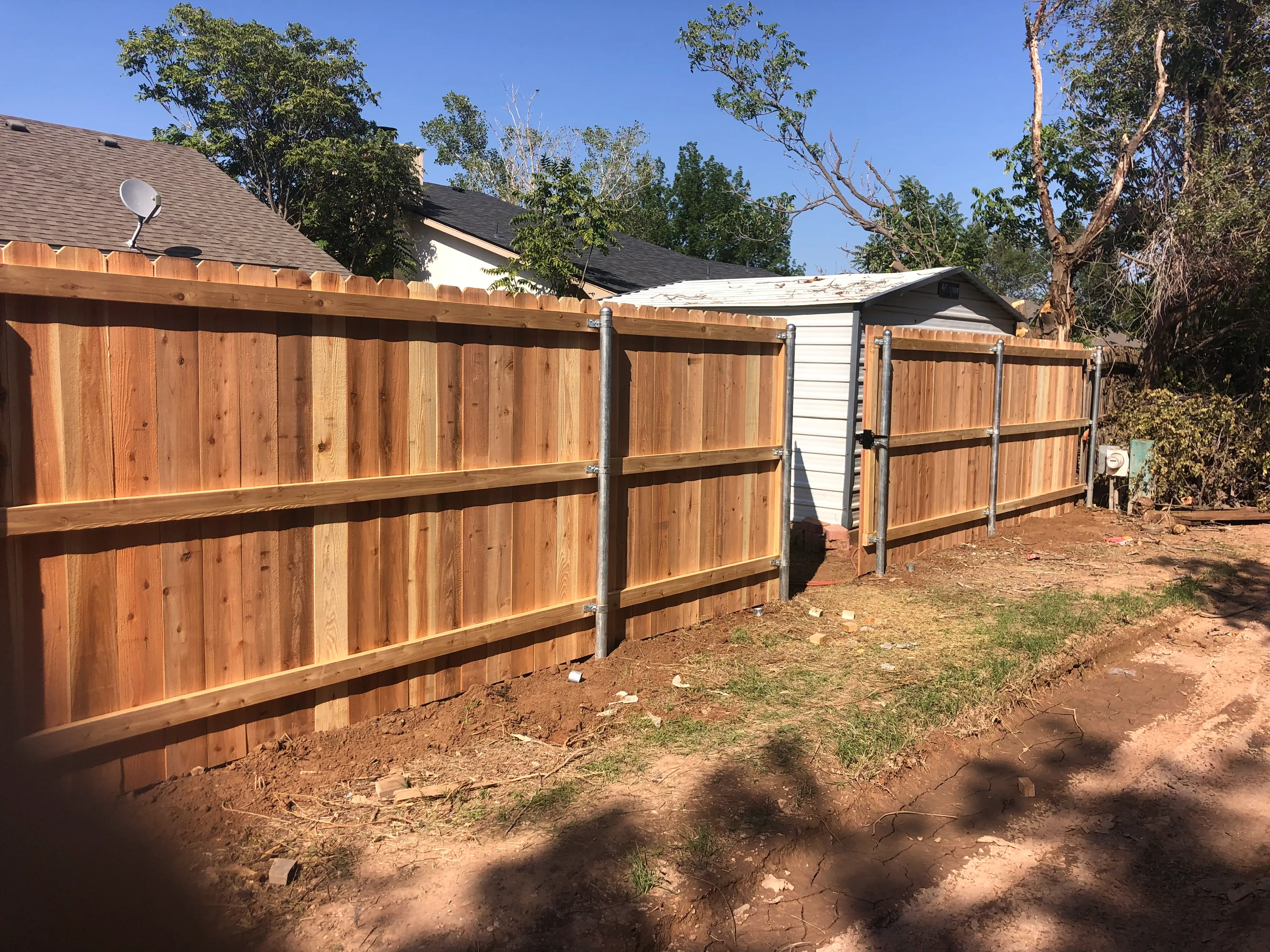 Full backyard enclosure using fresh cedar privacy fencing