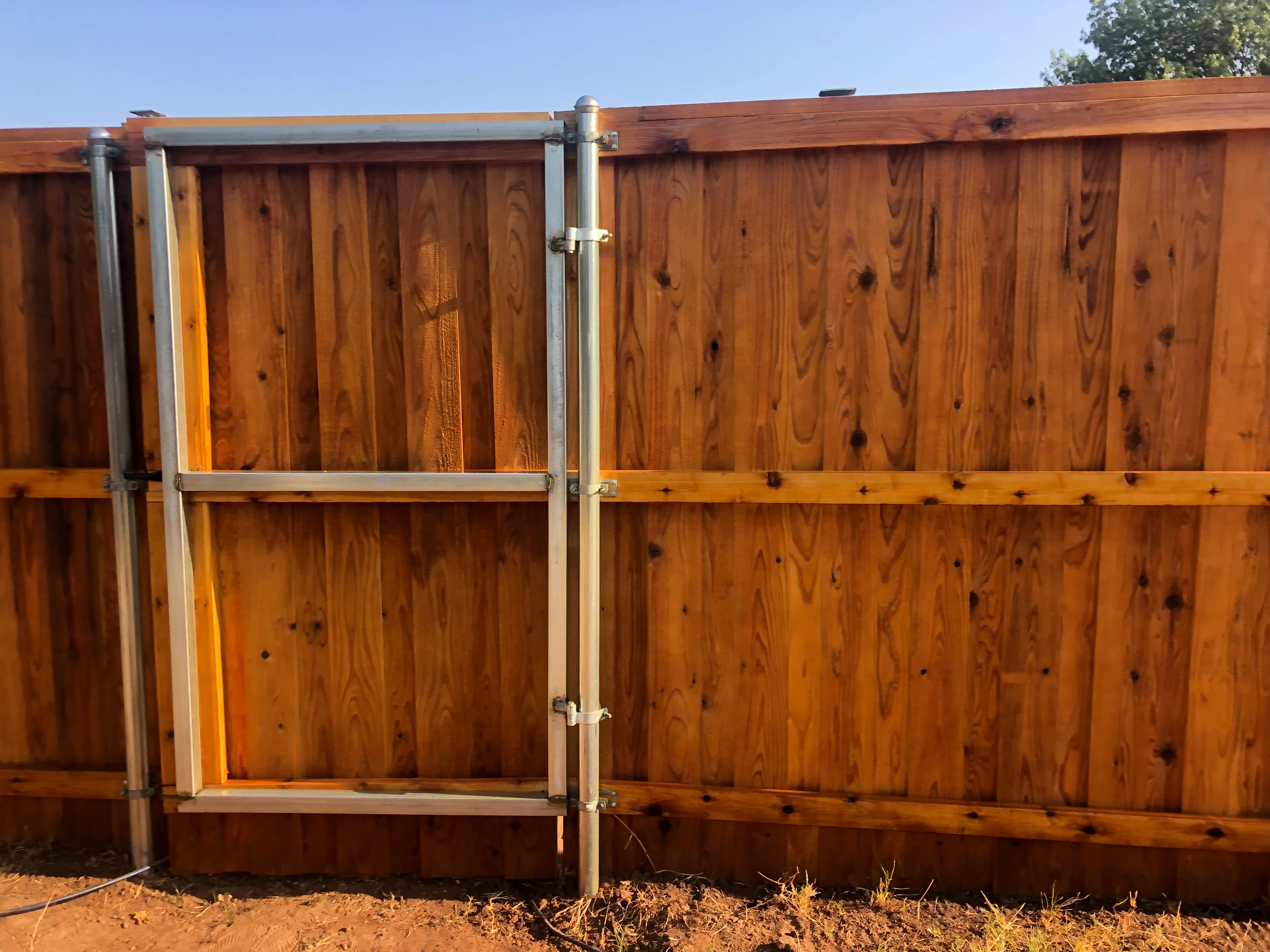 Six-foot-wide steel-frame cedar privacy gate installed in Fort Worth Texas
