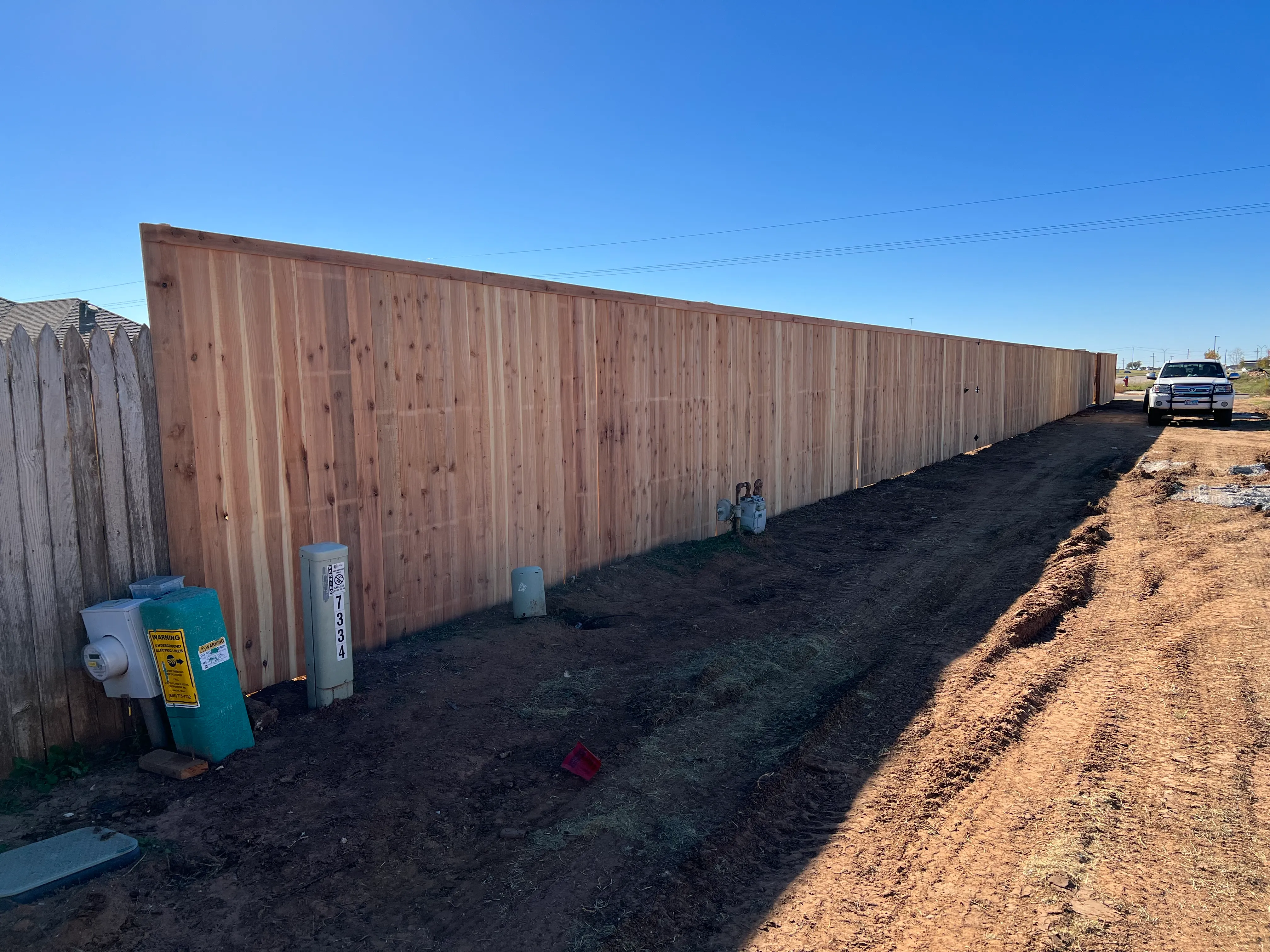 7-foot cedar fence protecting full property line in Lubbock Texas