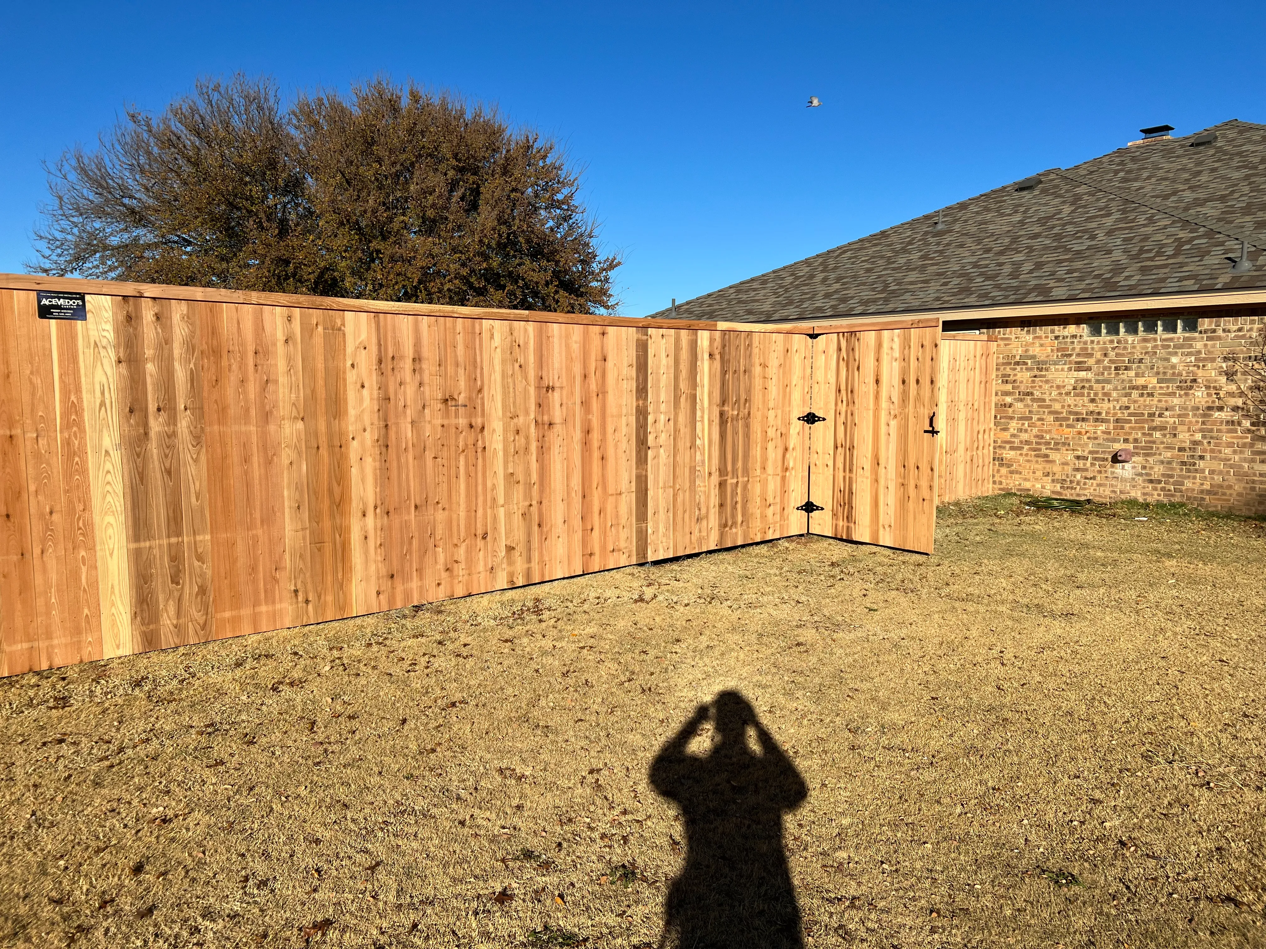 Six-foot-wide cedar privacy gate built into seven-foot fence line