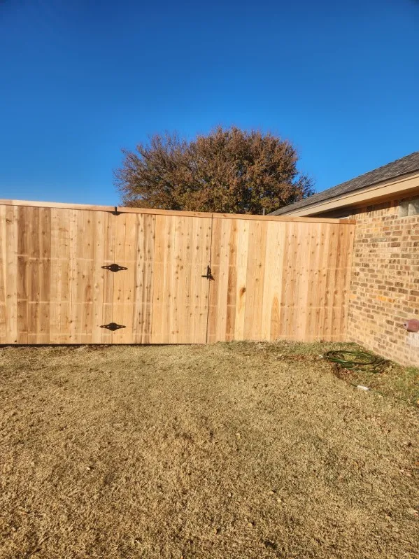 Seven-foot-tall by six-foot-wide custom cedar gate with triple hinges installed in Keller Texas