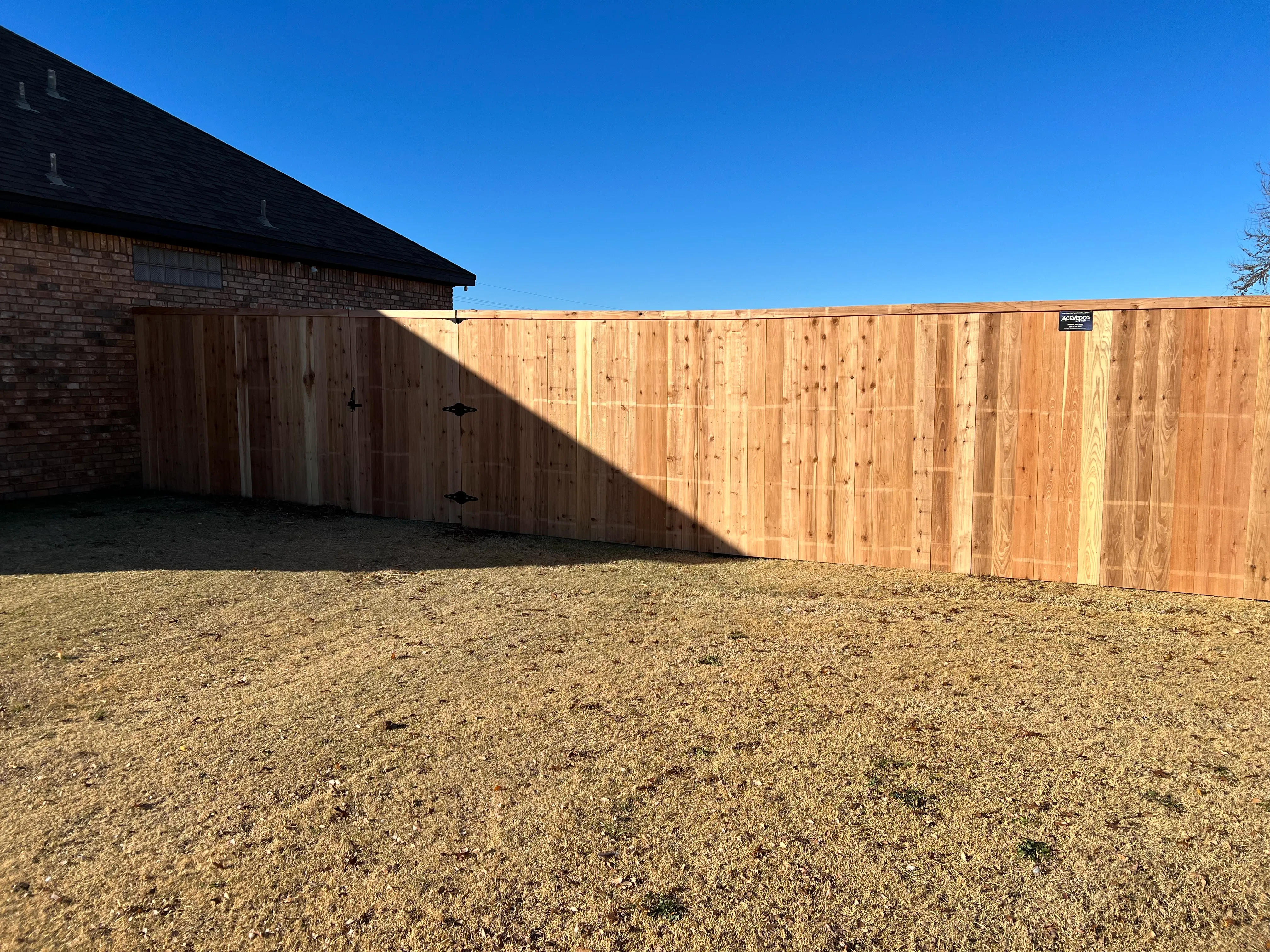 Full-height cedar privacy fence surrounding backyard for maximum coverage