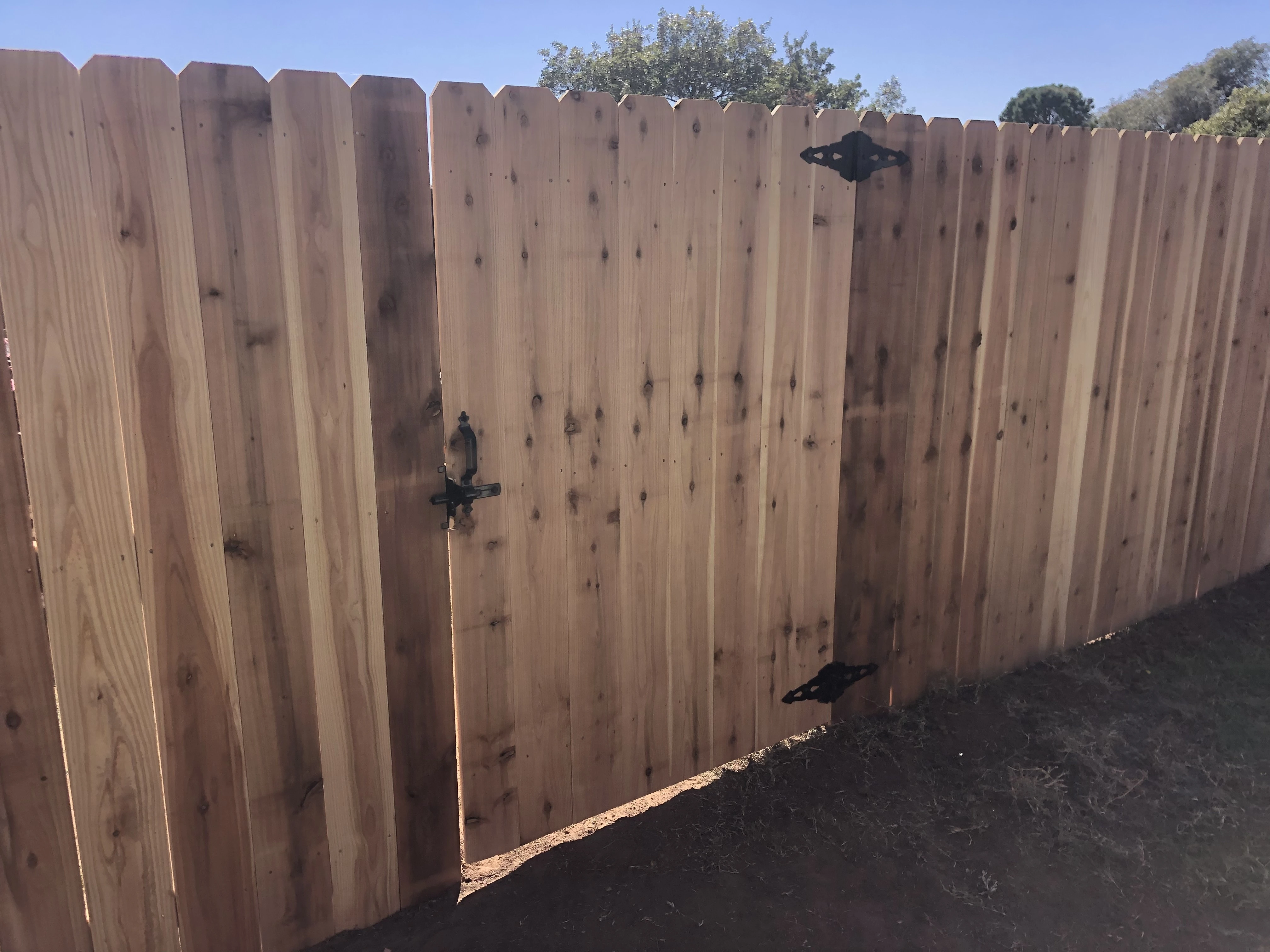 Cedar dog-ear gate repair with steel frame — re-leveled, reinforced, storm-damage fix in Lubbock, TX