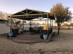 Custom 15x15 backyard cedar pergola with deck and railings installed in Lubbock TX