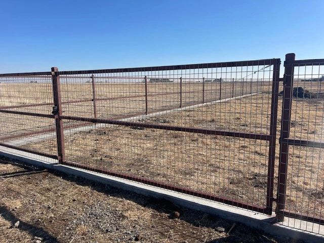 10'-wide steel frame ranch-rail gate with welded wire infill for pasture access in Lubbock Texas