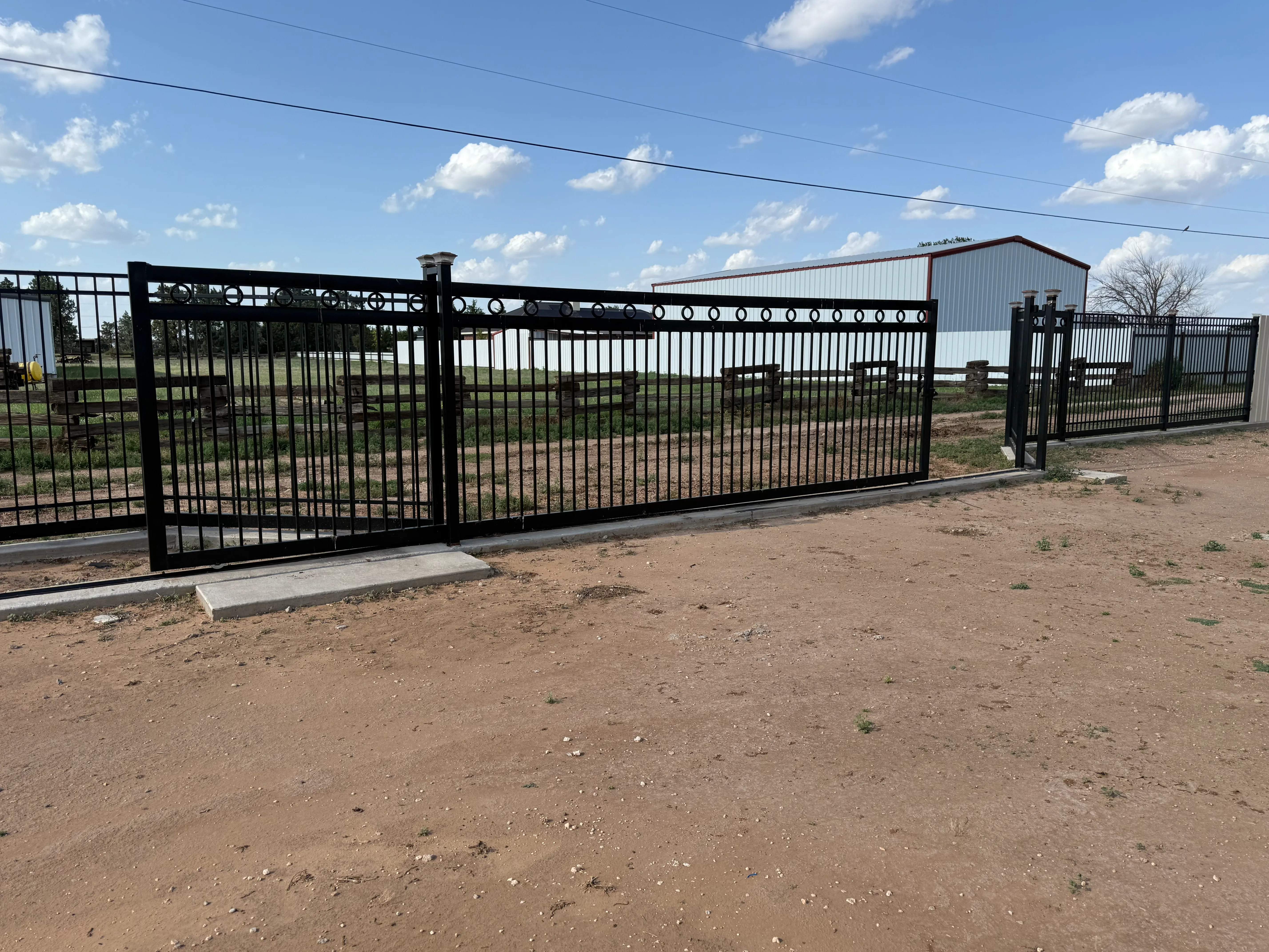 25-foot custom sliding steel driveway gate installed for ranch property in DFW area