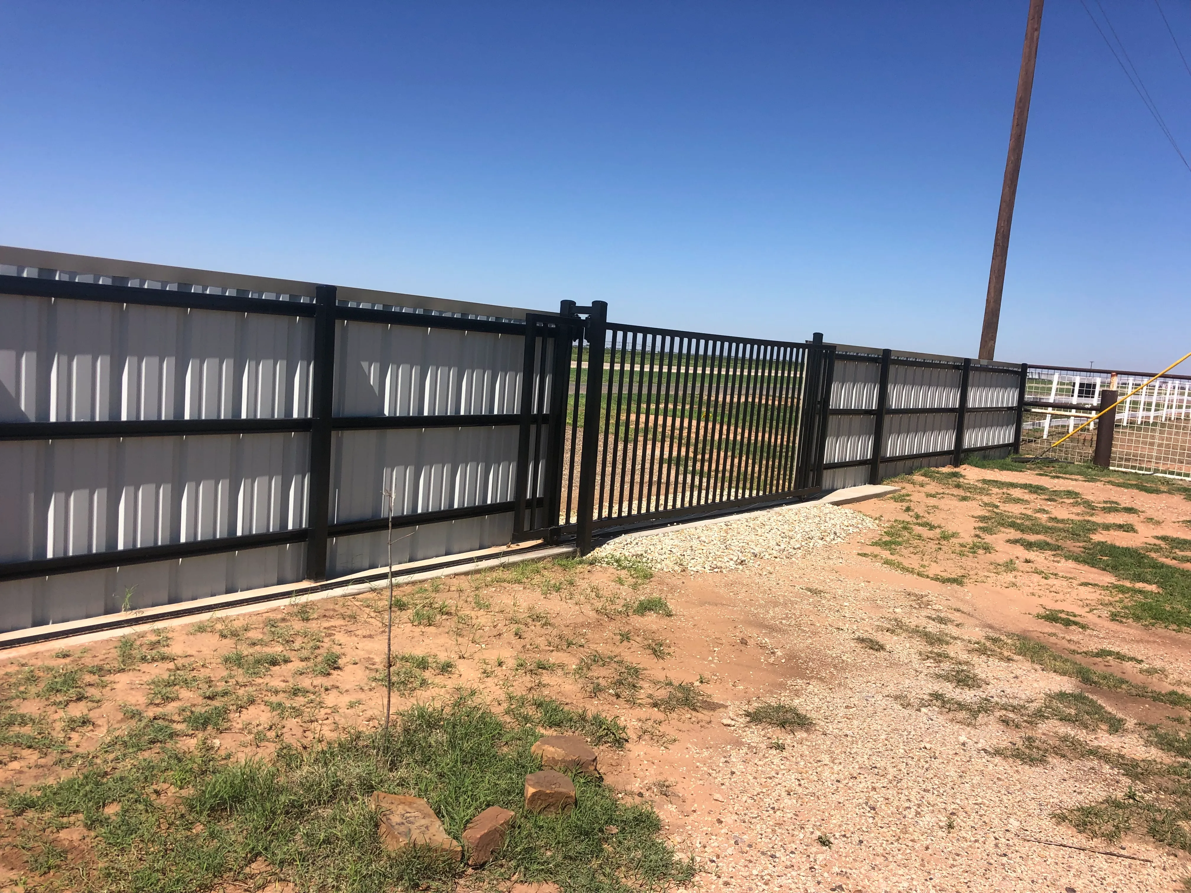 Metal fence with slider gate